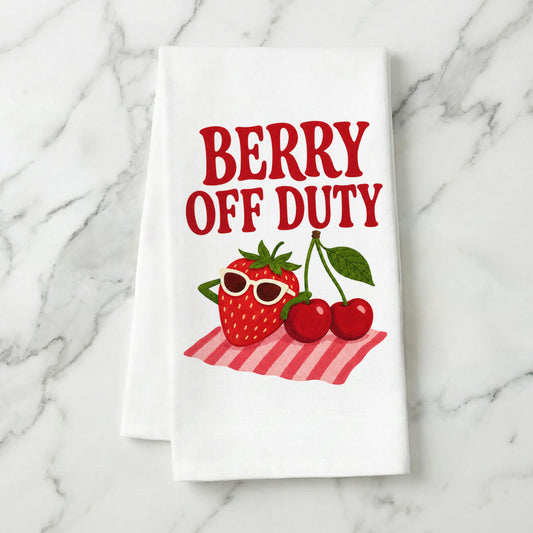 Berry Off Duty strawberry and cherry tea towel styled on a marble surface.