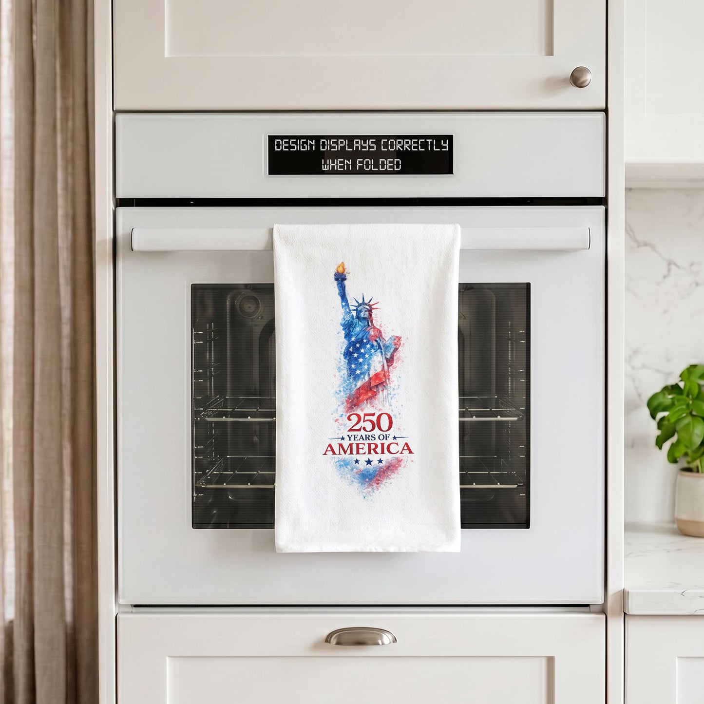 250 Years of America Statue of Liberty tea towel hanging from an oven handle