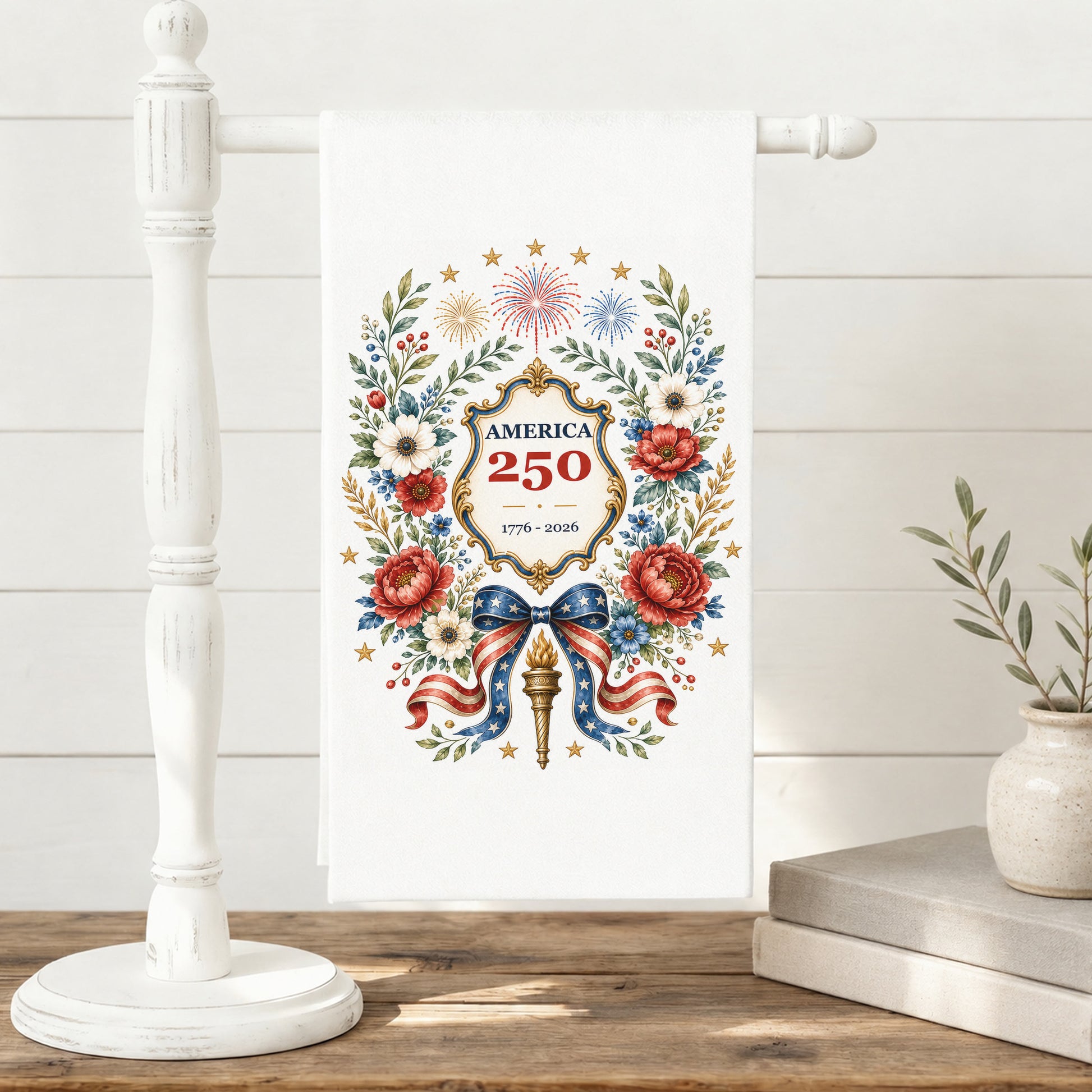 America 250 botanical wreath tea towel displayed on a towel stand with patriotic floral anniversary artwork