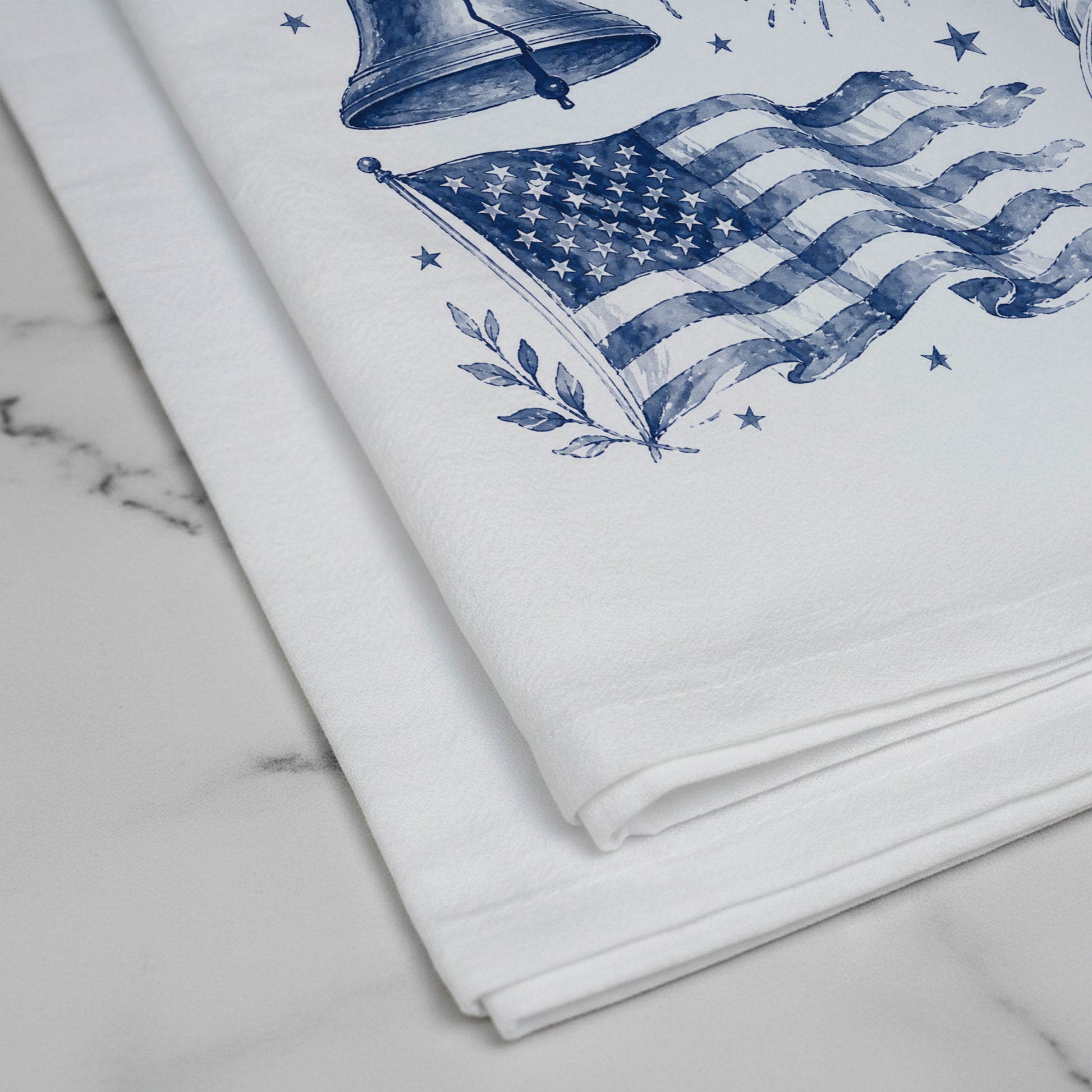 Close-up of the navy indigo print on the white flour sack tea towel showing the American flag and Liberty Bell toile detail