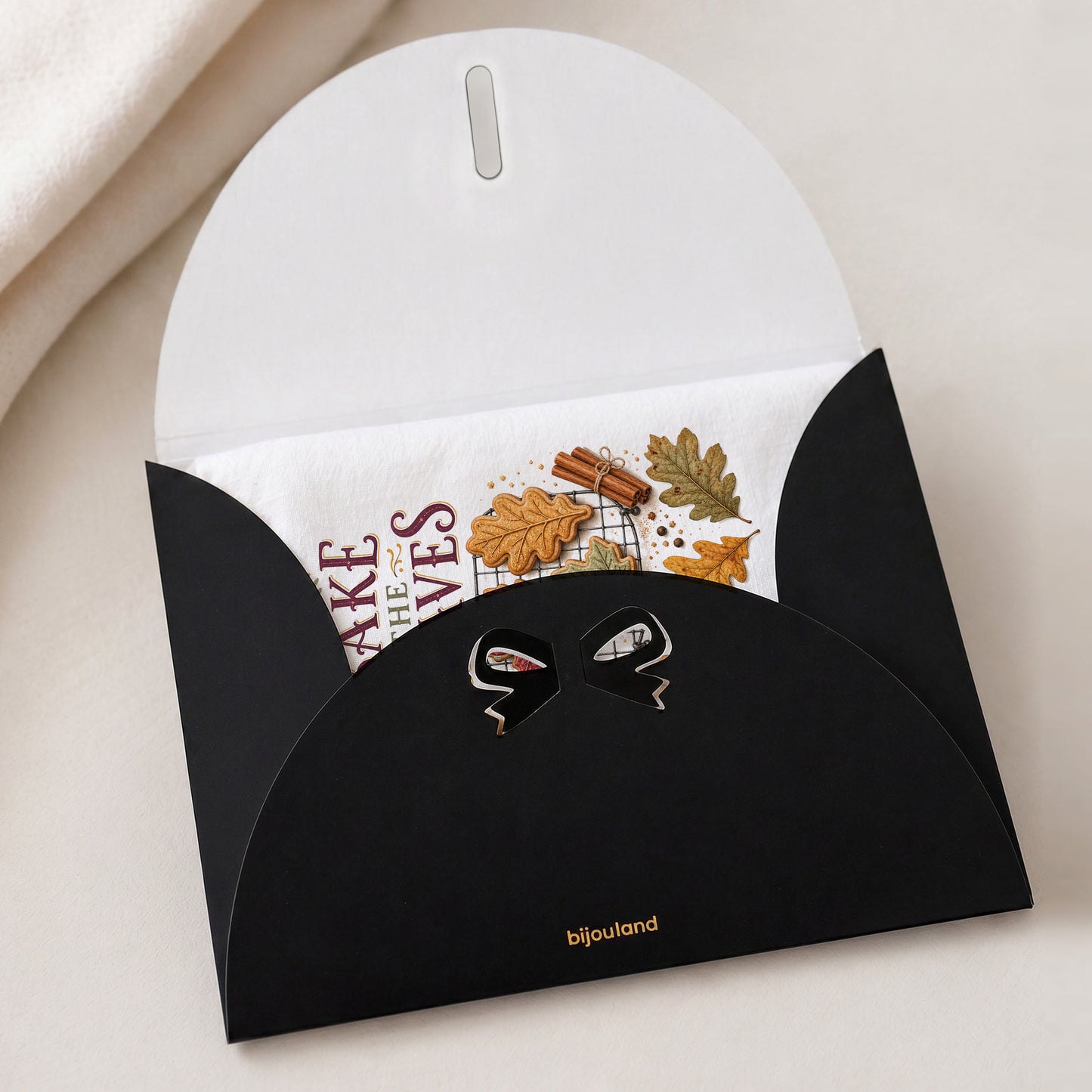 Bake the Leaves Fall Baking Tea Towel shown with the black Bijouland gift-envelope packaging option.