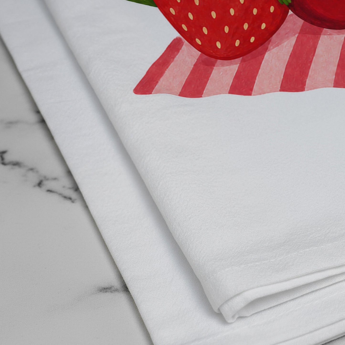 Close-up of the printed strawberry and cherry artwork on the Berry Off Duty cotton tea towel.
