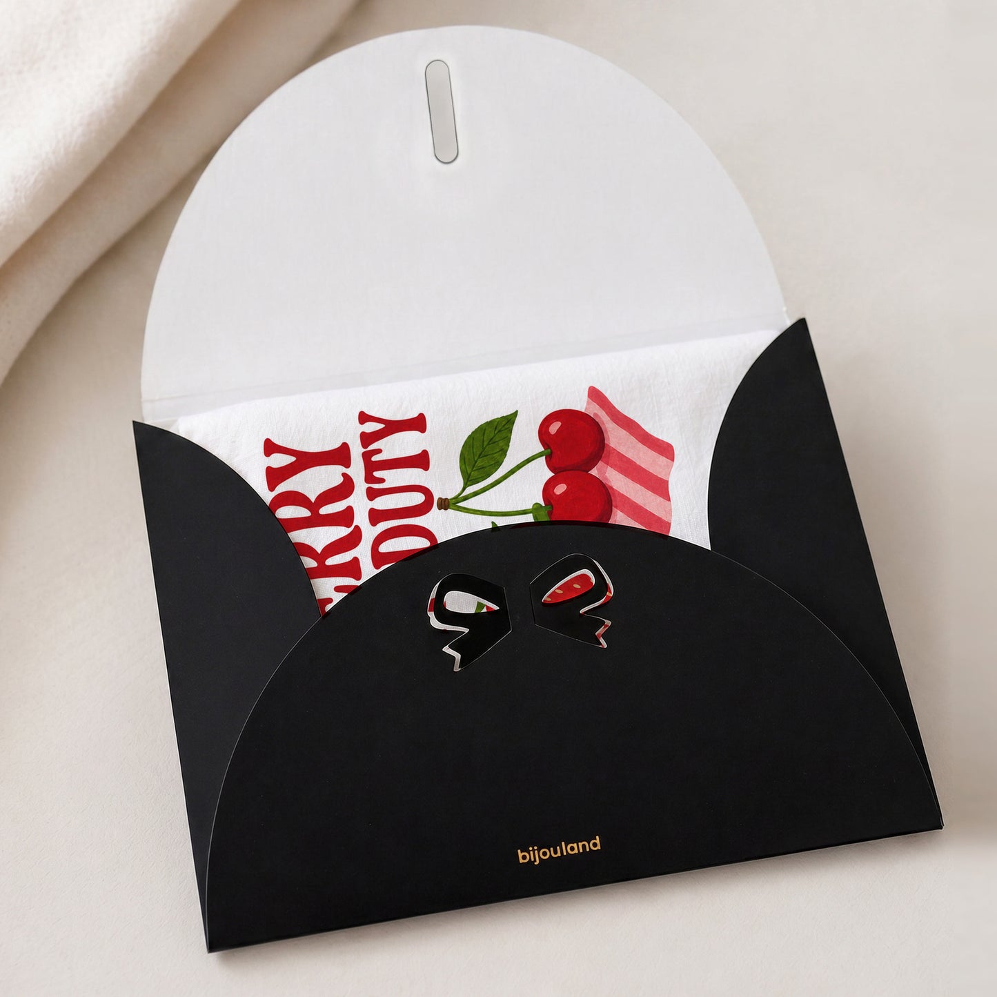 Berry Off Duty tea towel shown with the Bijouland gift-envelope packaging option.