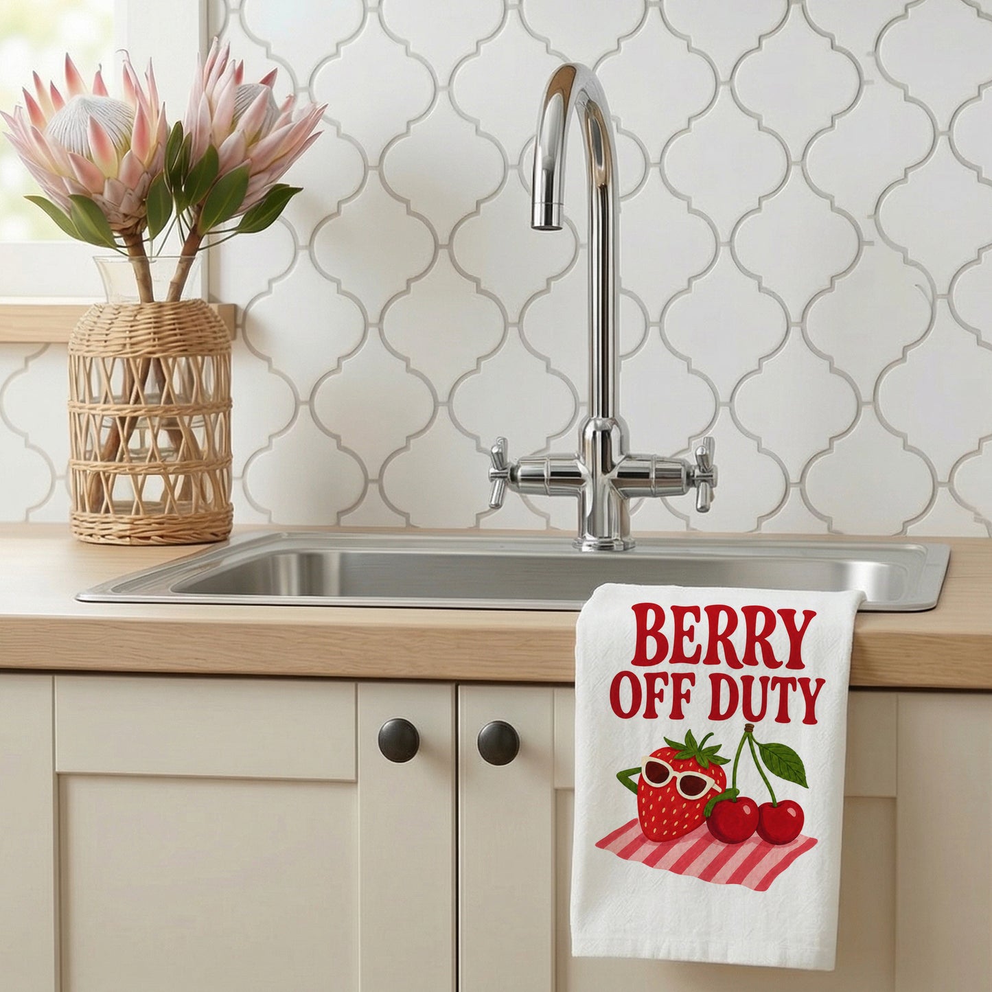 Berry Off Duty tea towel styled beside a kitchen sink with the fruit design visible.