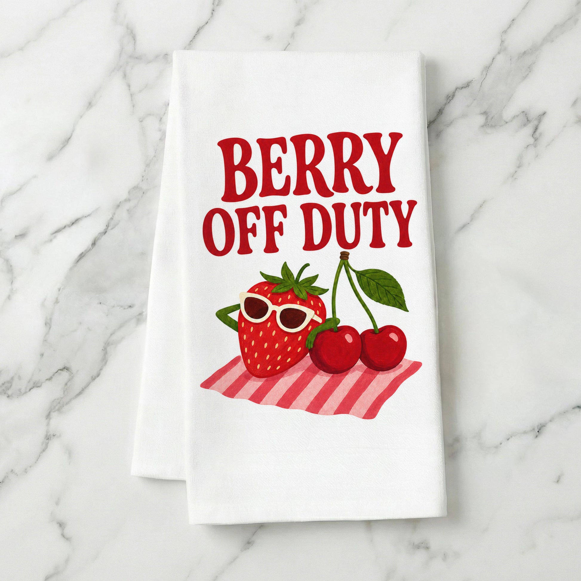 Berry Off Duty strawberry and cherry tea towel styled on a marble surface.