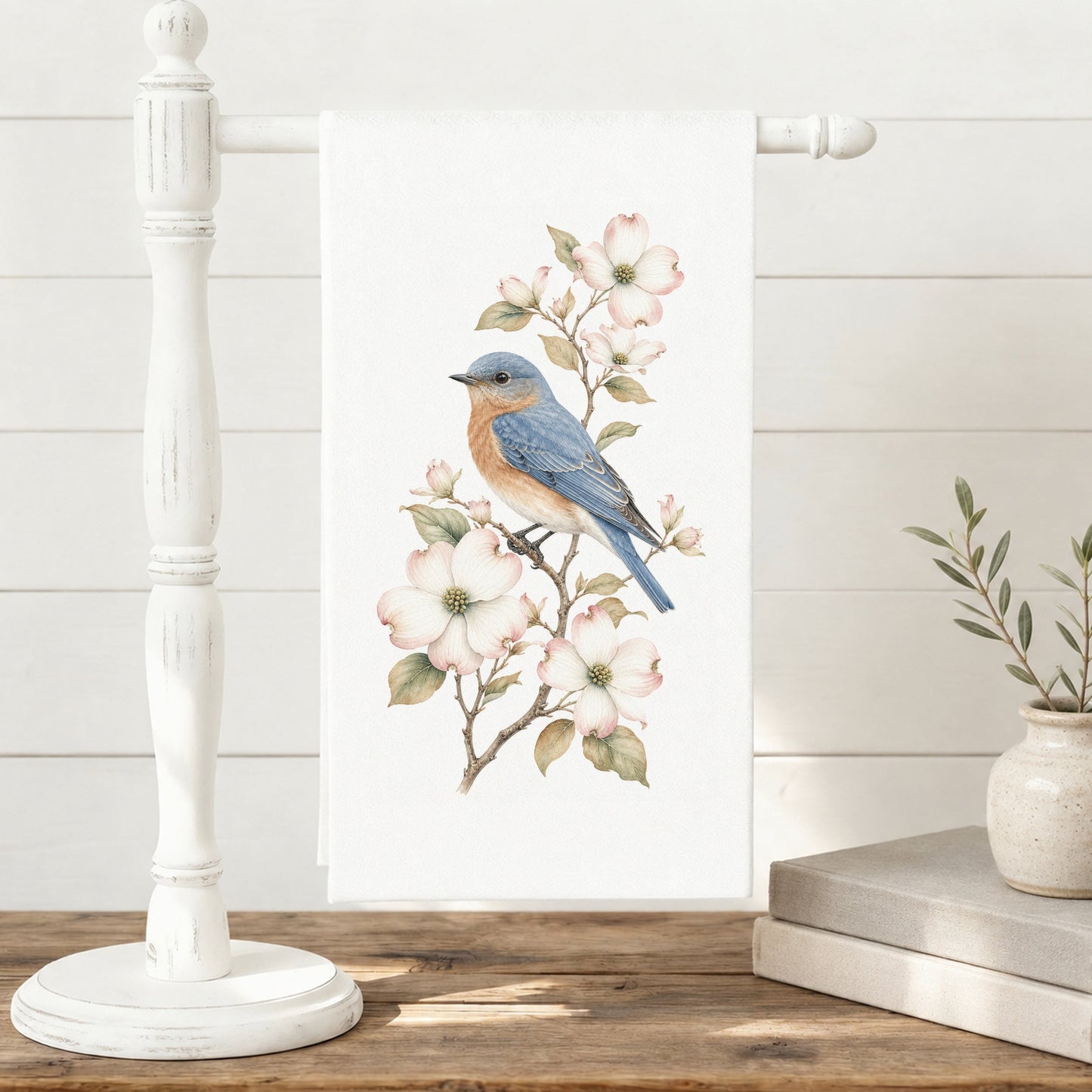 Bluebird and dogwood tea towel displayed on a towel stand