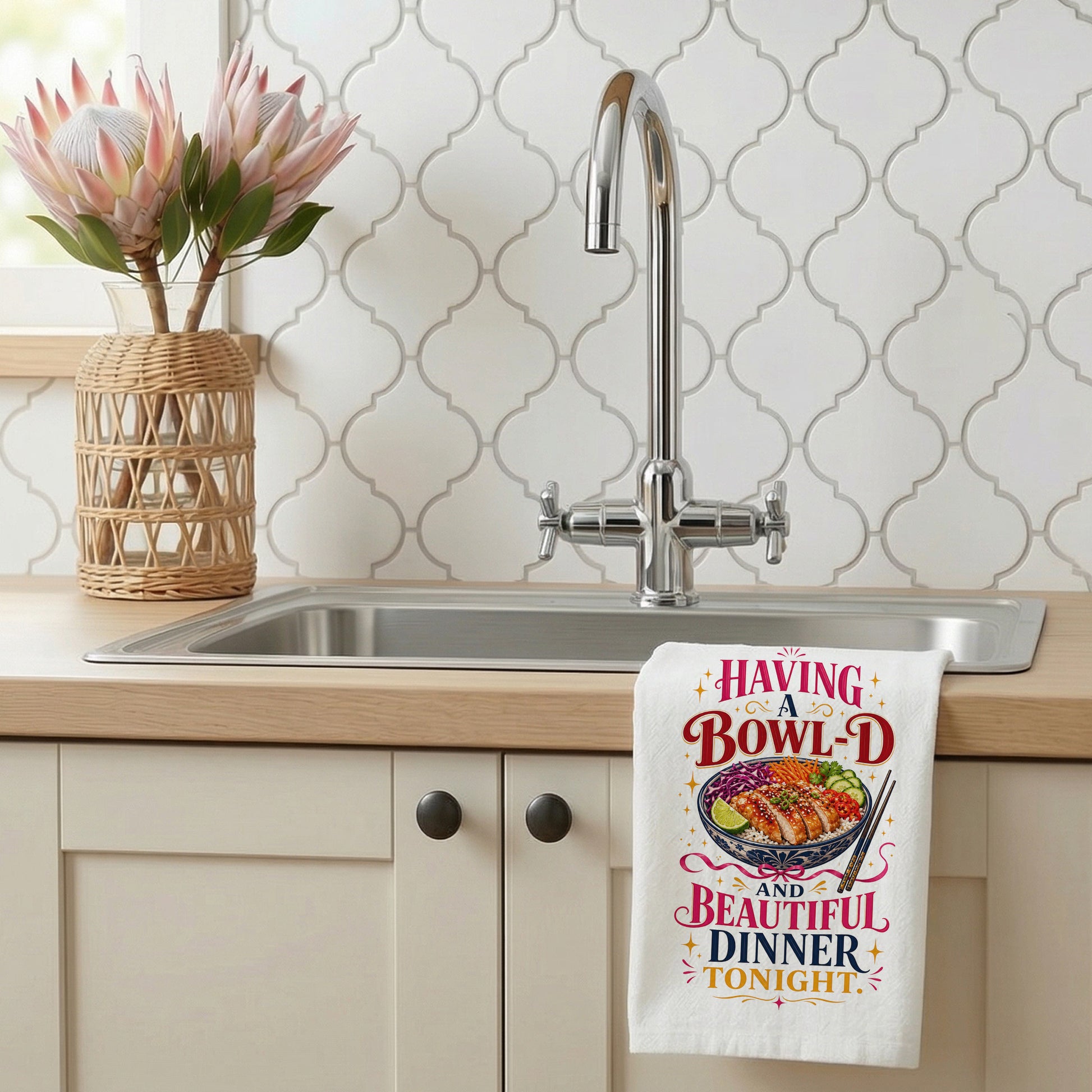 Bowl-d and Beautiful chicken rice dinner pun kitchen towel styled beside a sink with the design visible.