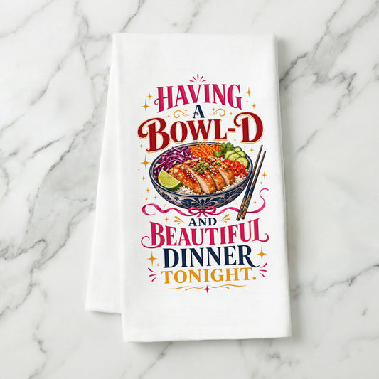 Bowl-d and Beautiful chicken rice dinner pun organic cotton kitchen towel styled on a white marble surface.
