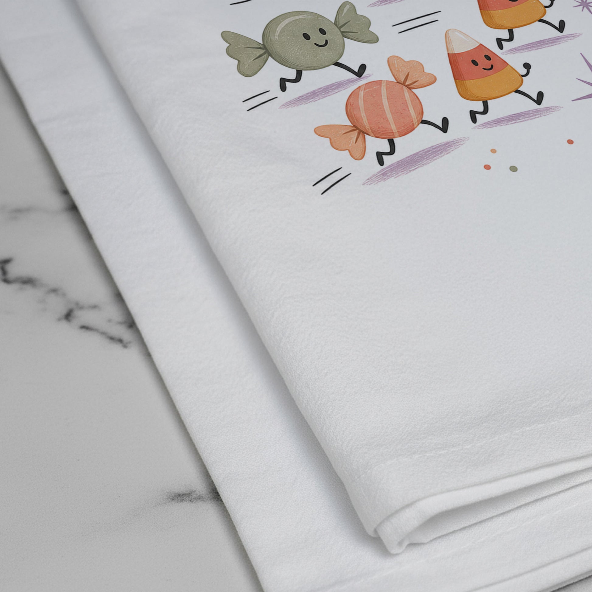 Close-up of the Candy Curfew Retro Halloween Kitchen Towel print showing cheerful pastel candies, candy corn, small door, clock, moon, and checkerboard accents on white flour sack organic cotton.
