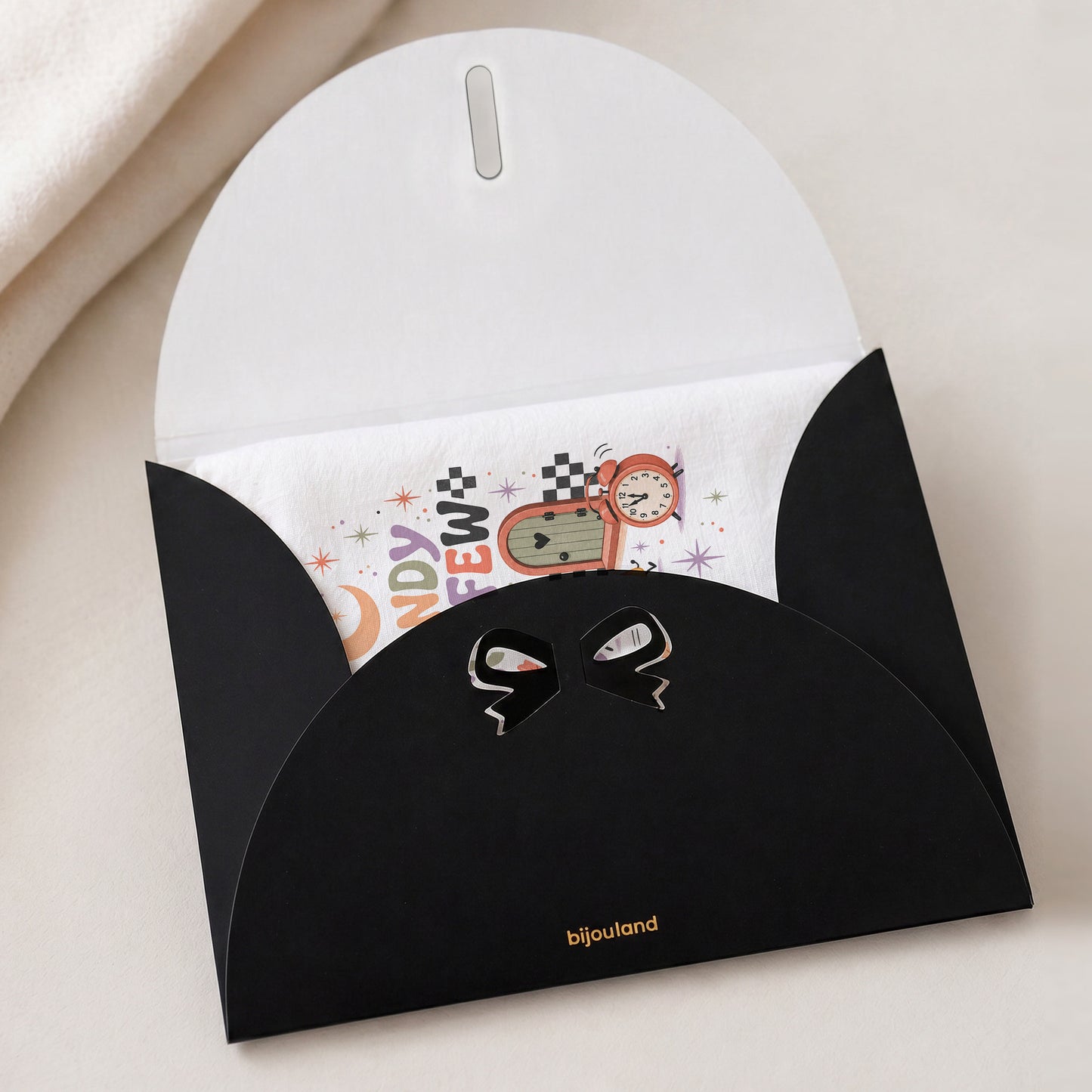 Candy Curfew Retro Halloween Kitchen Towel shown with the black Bijouland gift-envelope packaging option.