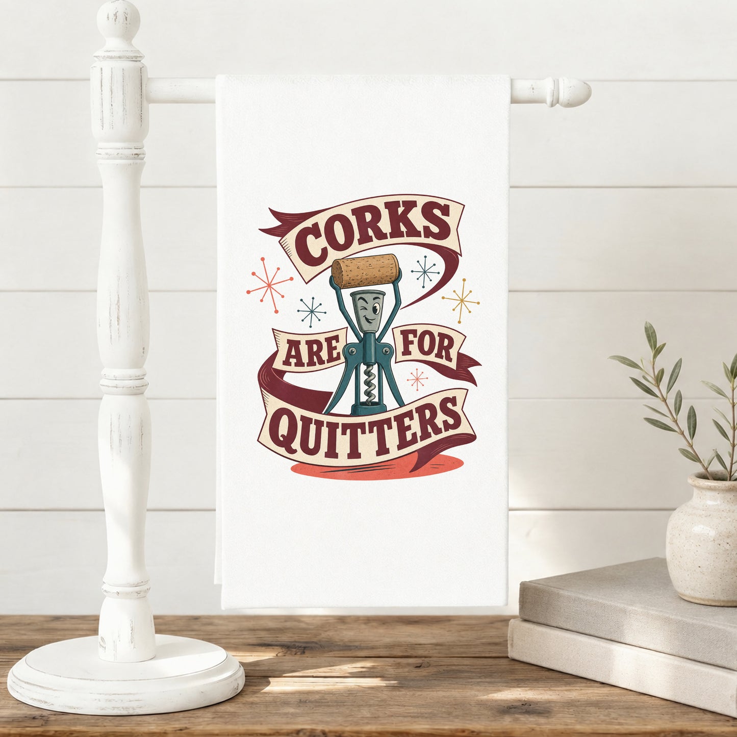 Corks Are for Quitters tea towel hanging neatly on a kitchen towel stand.