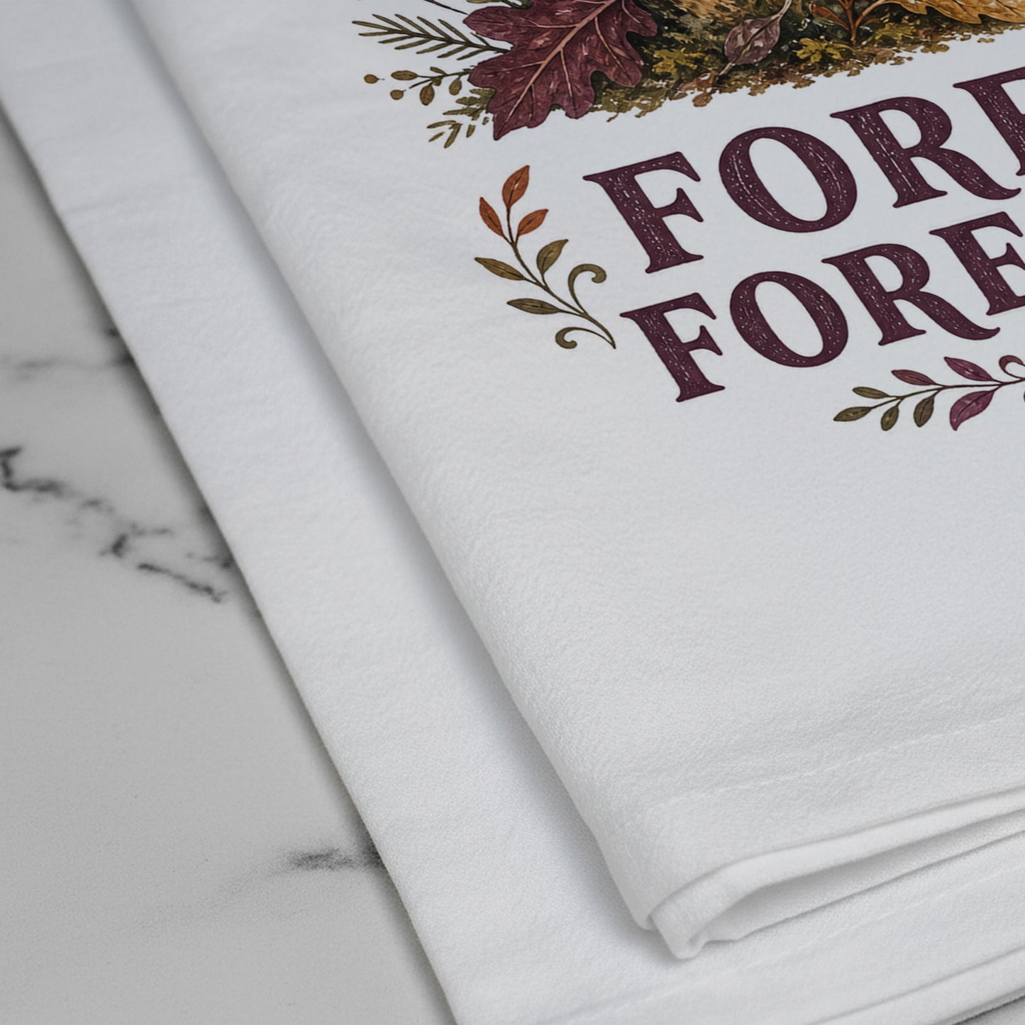 Close-up of the Forest Forecast Mushroom Tea Towel print showing woodland mushrooms, autumn leaves, sun, rain cloud, wind, and burgundy lettering on white flour sack organic cotton.
