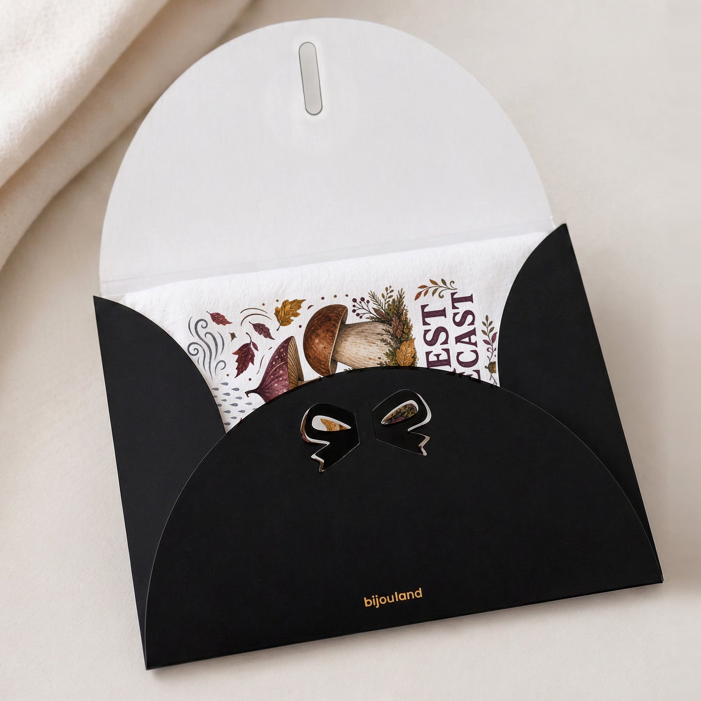 Forest Forecast Mushroom Tea Towel shown with the black Bijouland gift-envelope packaging option.