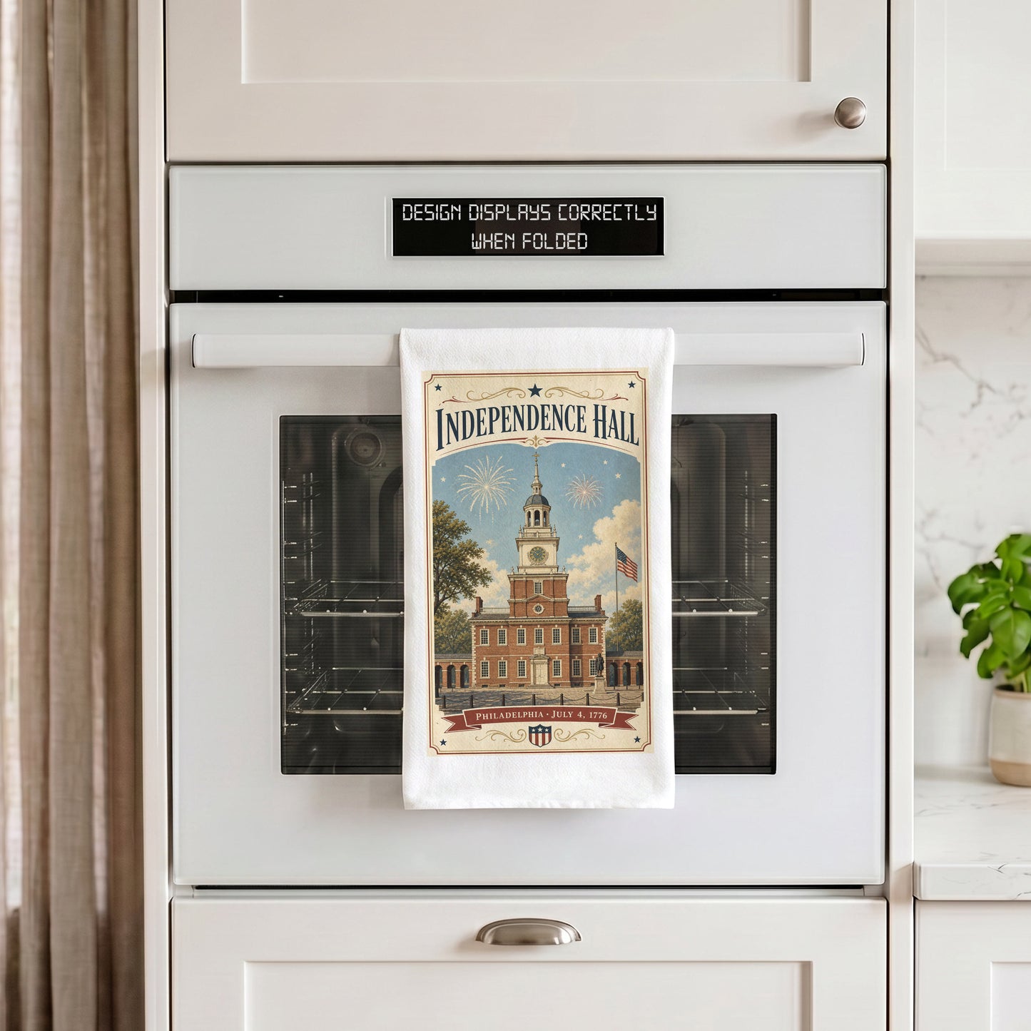 Independence Hall postcard tea towel hanging from an oven handle