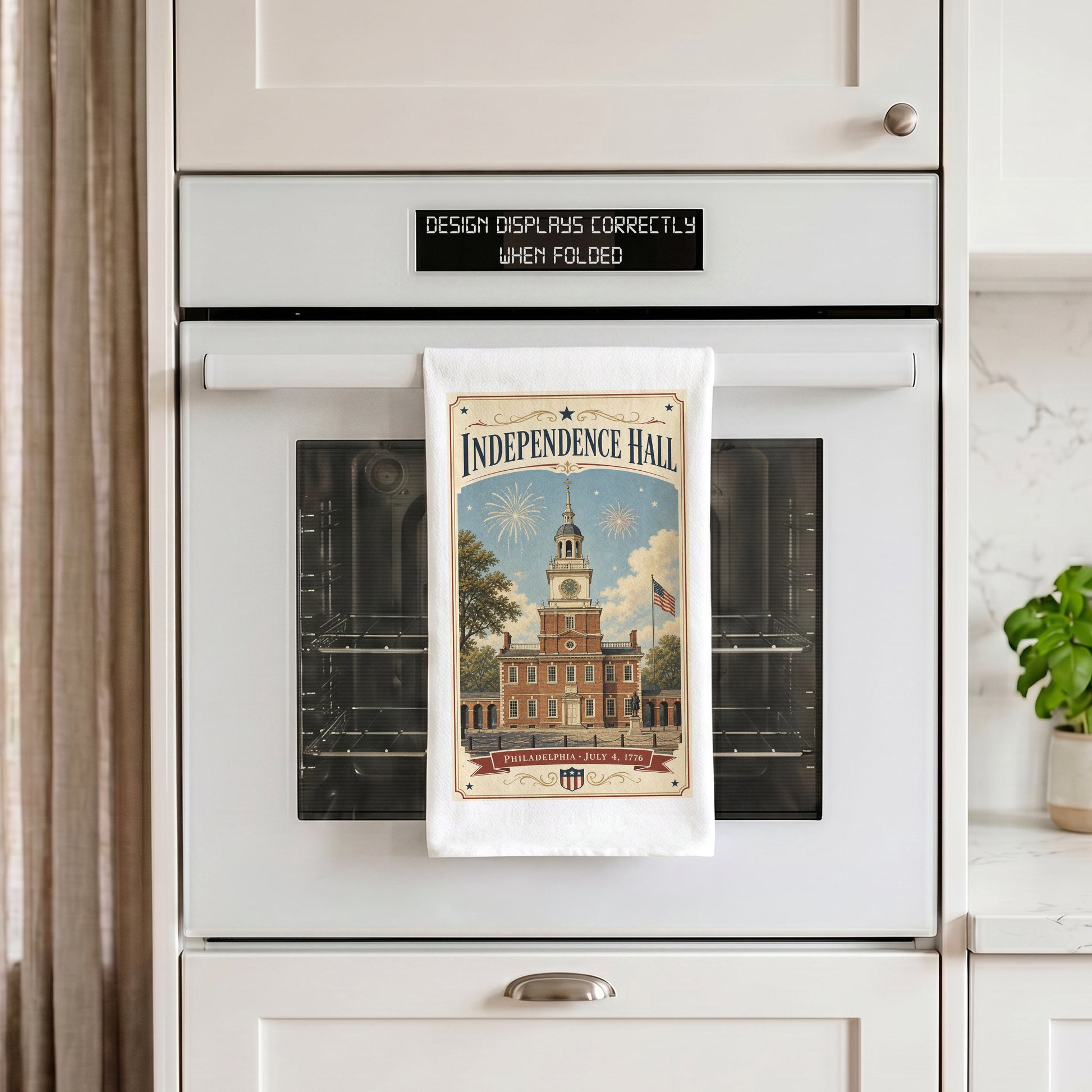 Independence Hall postcard tea towel hanging from an oven handle