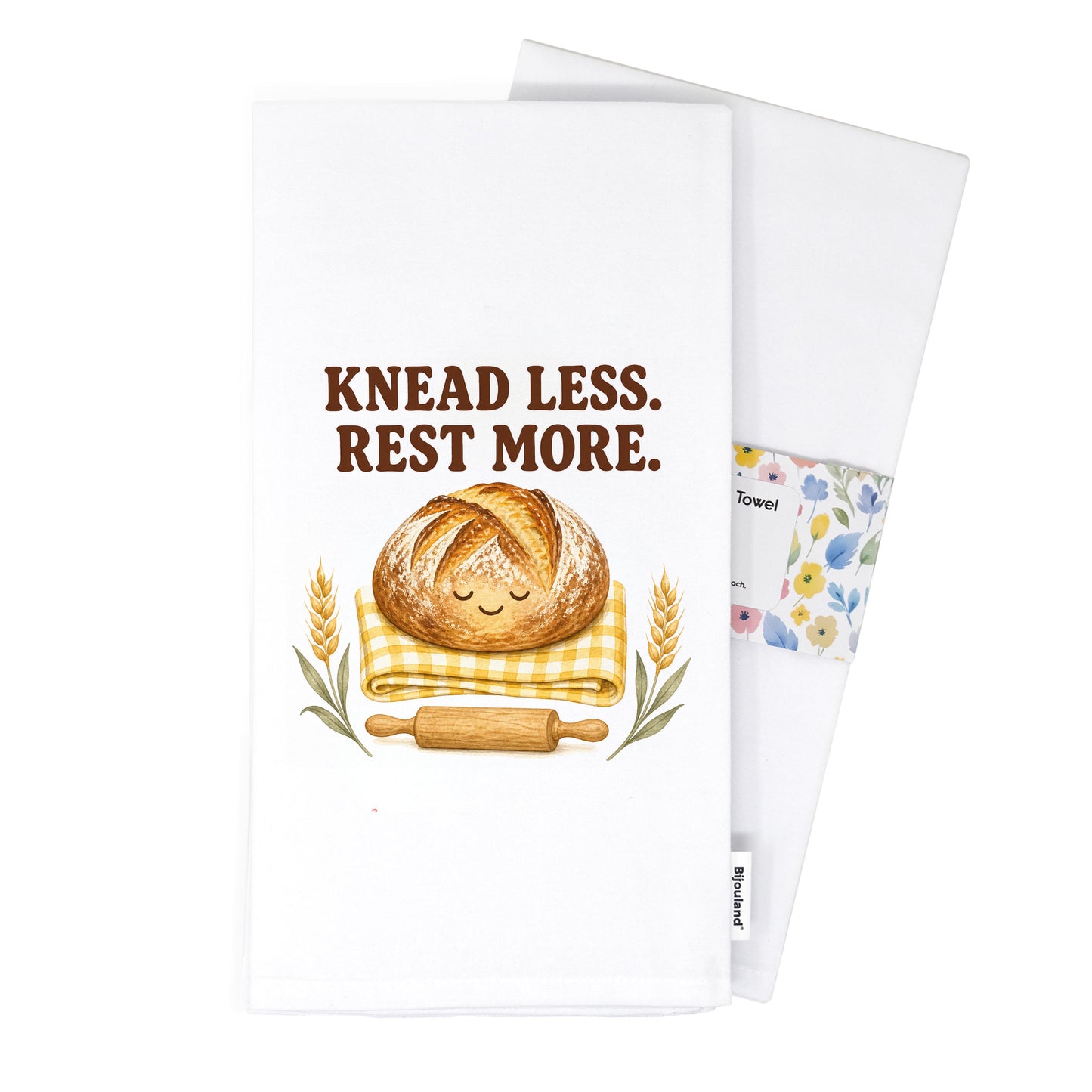 Folded Knead Less Rest More tea towel presented with its paper belly band.