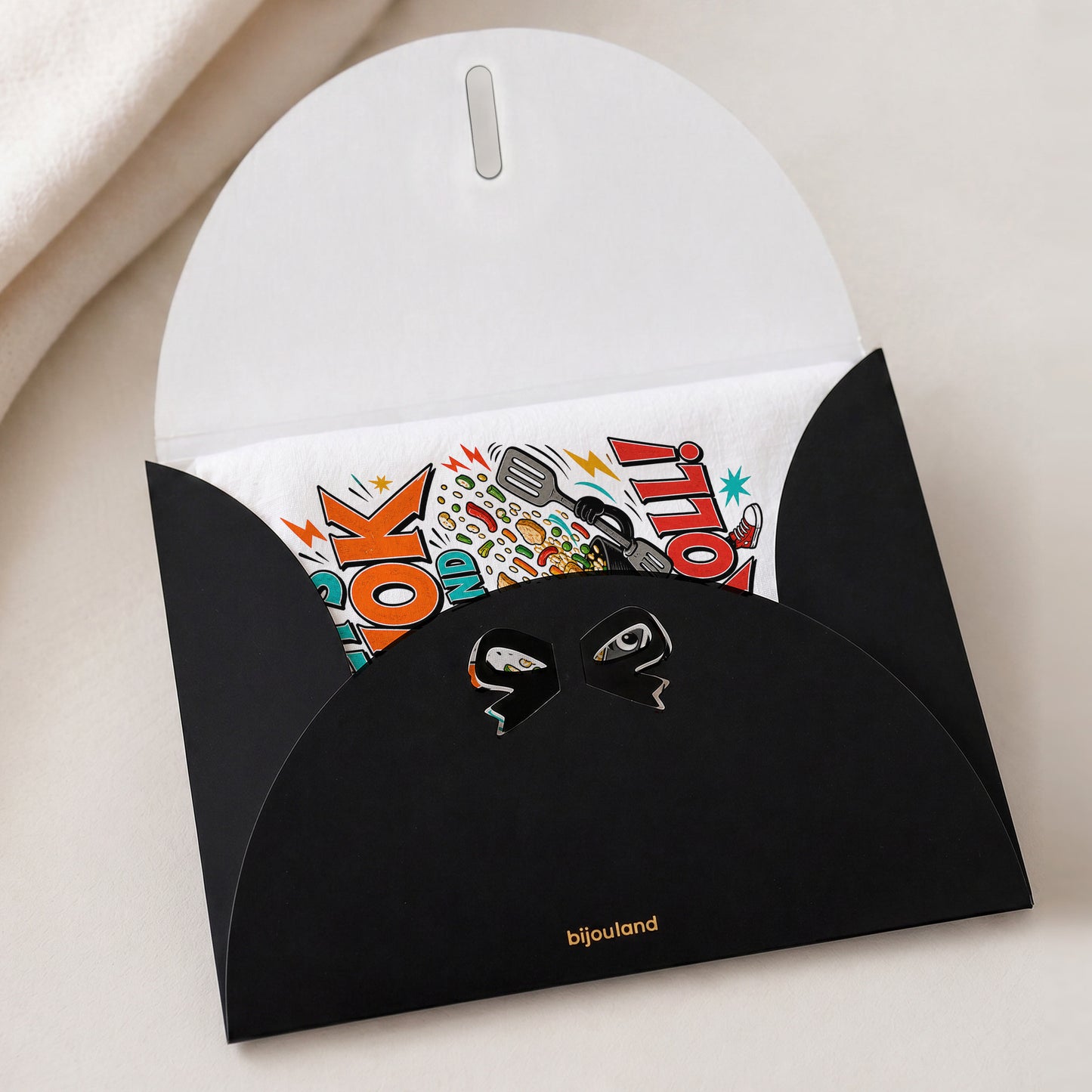 Let's Wok and Roll funny wok cooking pun tea towel shown with the Bijouland gift-envelope packaging option.