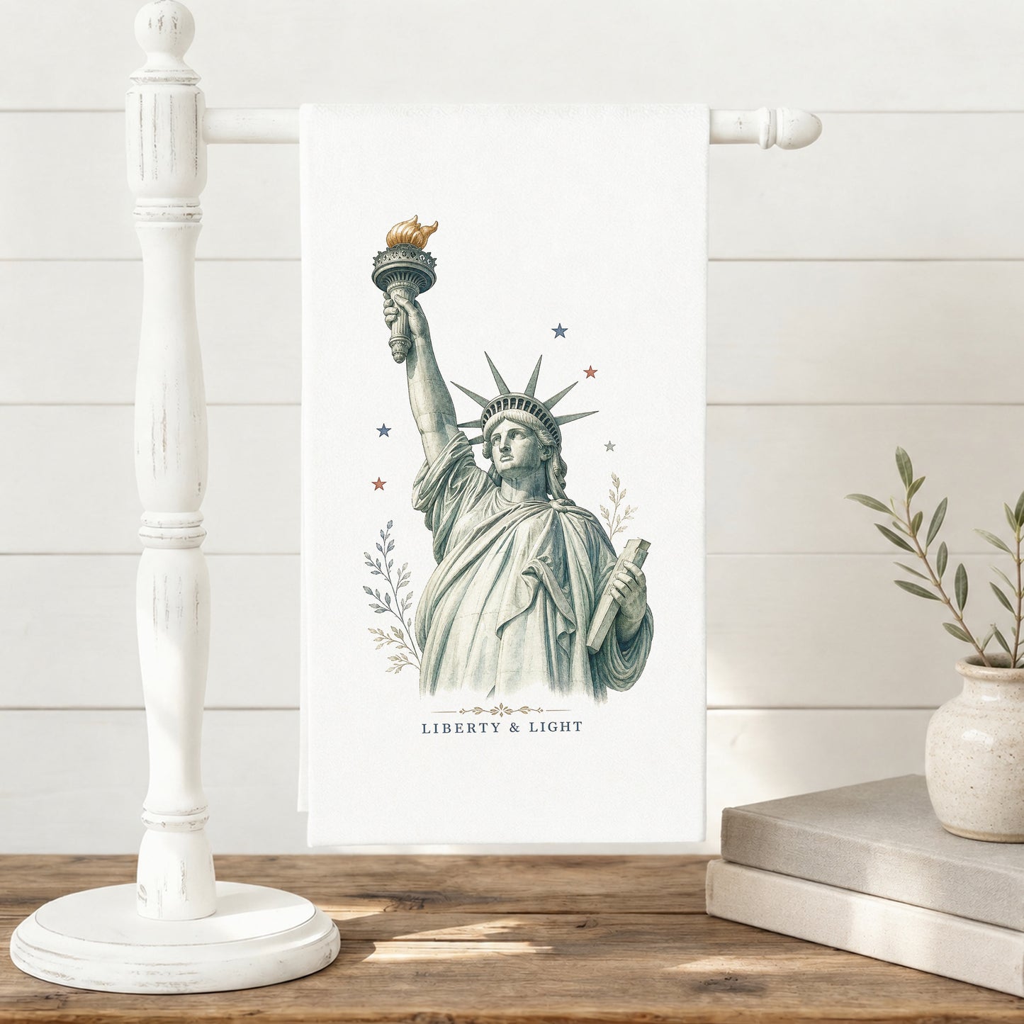 Liberty and Light Statue of Liberty tea towel displayed on a towel stand