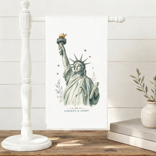 Liberty and Light Statue of Liberty tea towel displayed on a towel stand