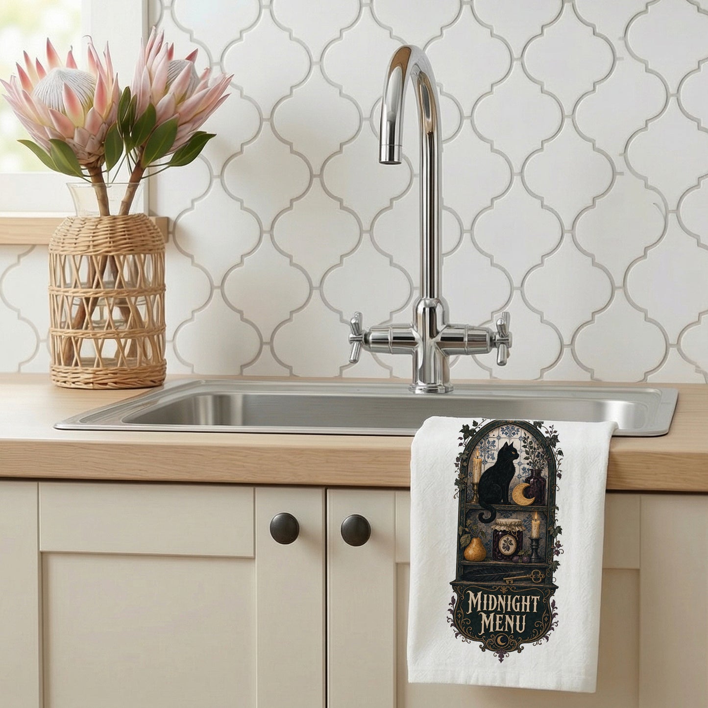 Midnight Menu Black Cat Halloween Kitchen Towel styled beside a bright kitchen sink, with black cat, candlelit pantry, moon cookie, pear, preserves, and antique details shown.