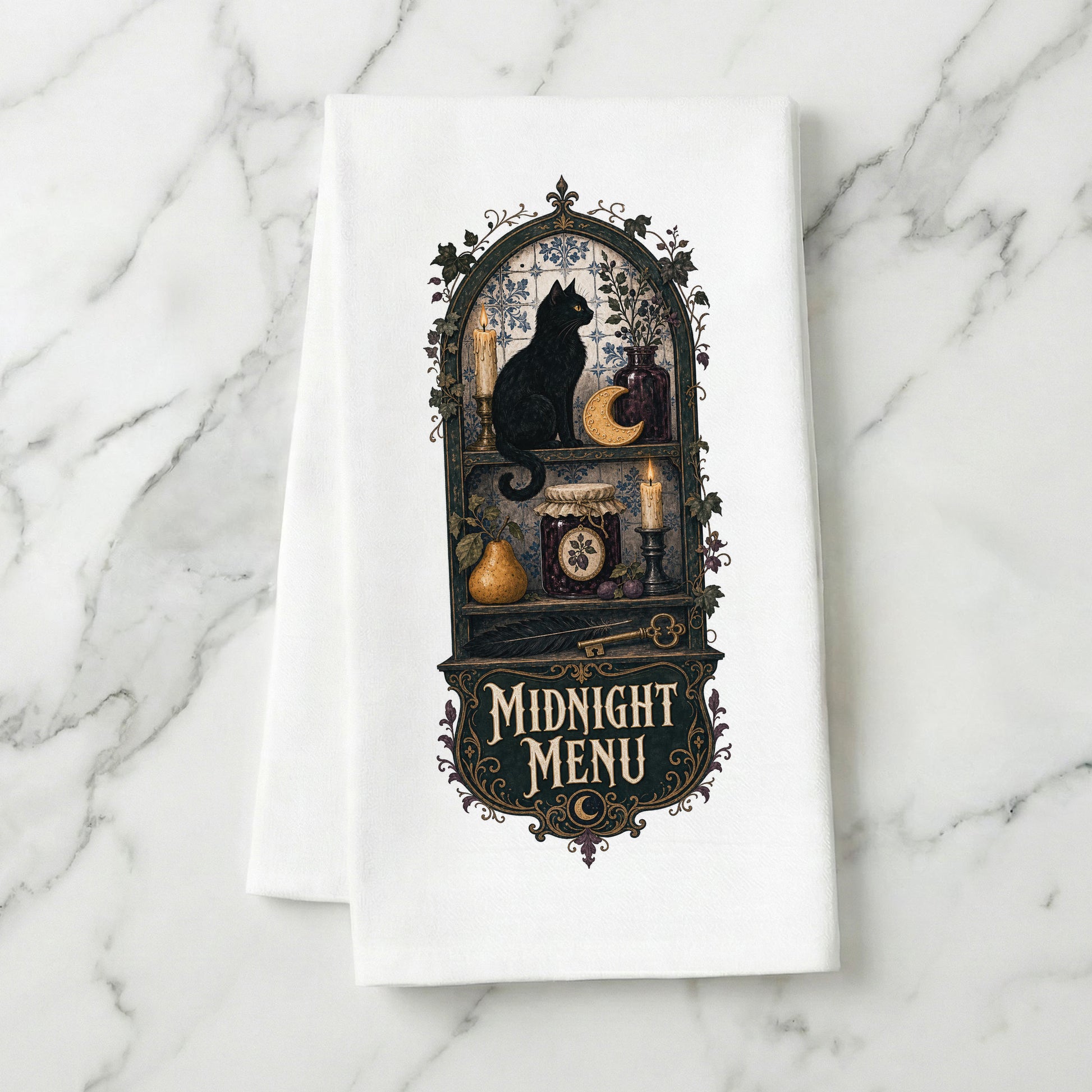 Midnight Menu Black Cat Halloween Kitchen Towel folded on white marble, with black cat, candlelit pantry, moon cookie, pear, preserves, and antique details clearly shown.