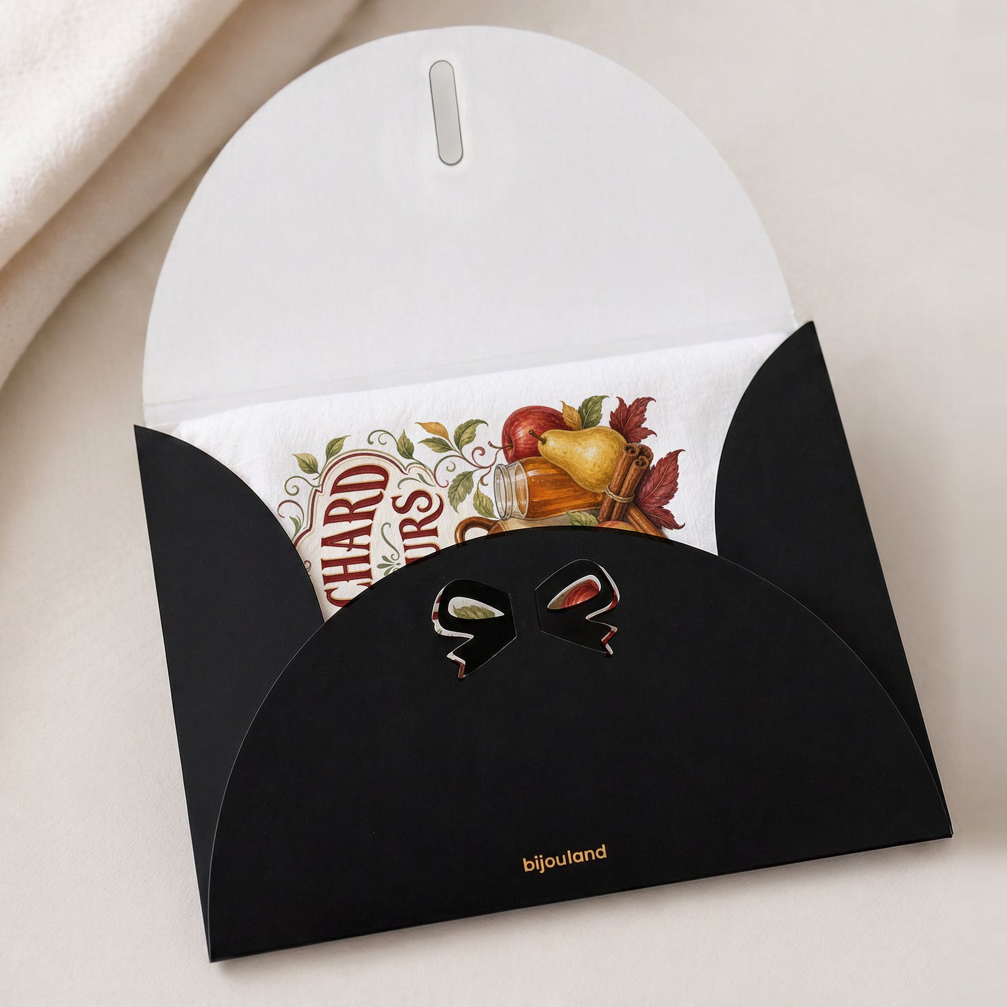Orchard Hours Apple Cider Tea Towel shown with the black Bijouland gift-envelope packaging option.