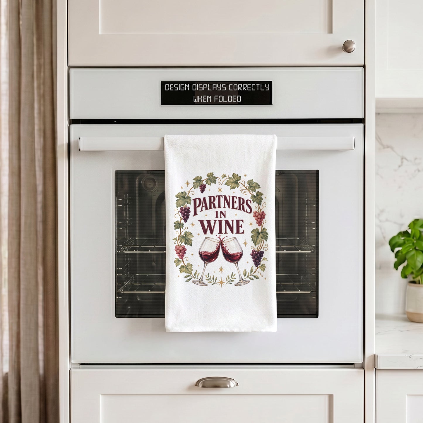 Partners in Wine tea towel hanging from an oven handle.