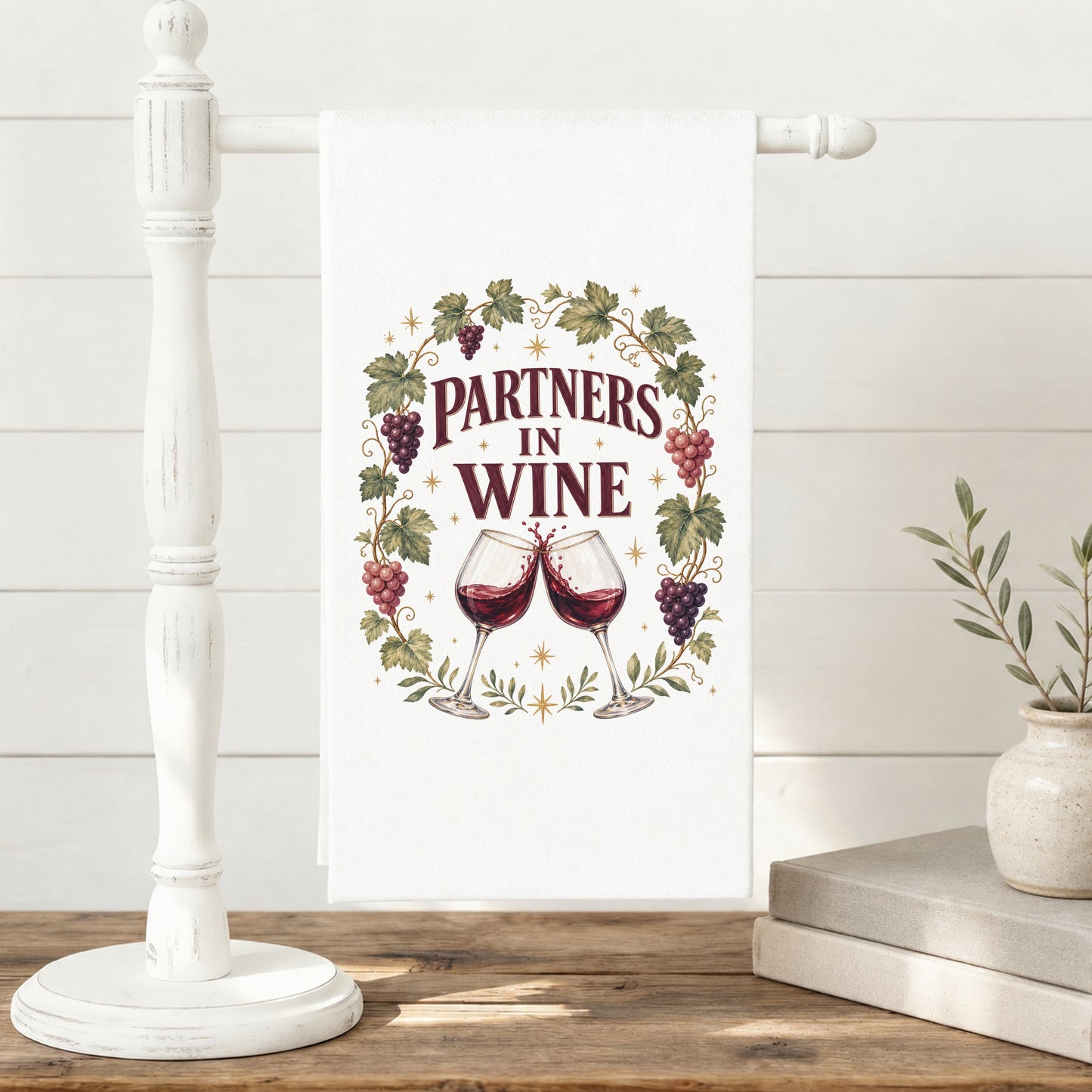 Partners in Wine tea towel hanging neatly on a kitchen towel stand.