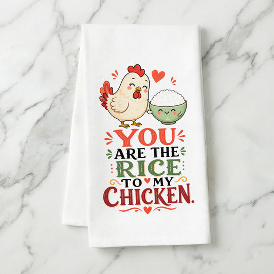You Are the Rice to My Chicken kawaii food pun organic cotton kitchen towel styled on a white marble surface.
