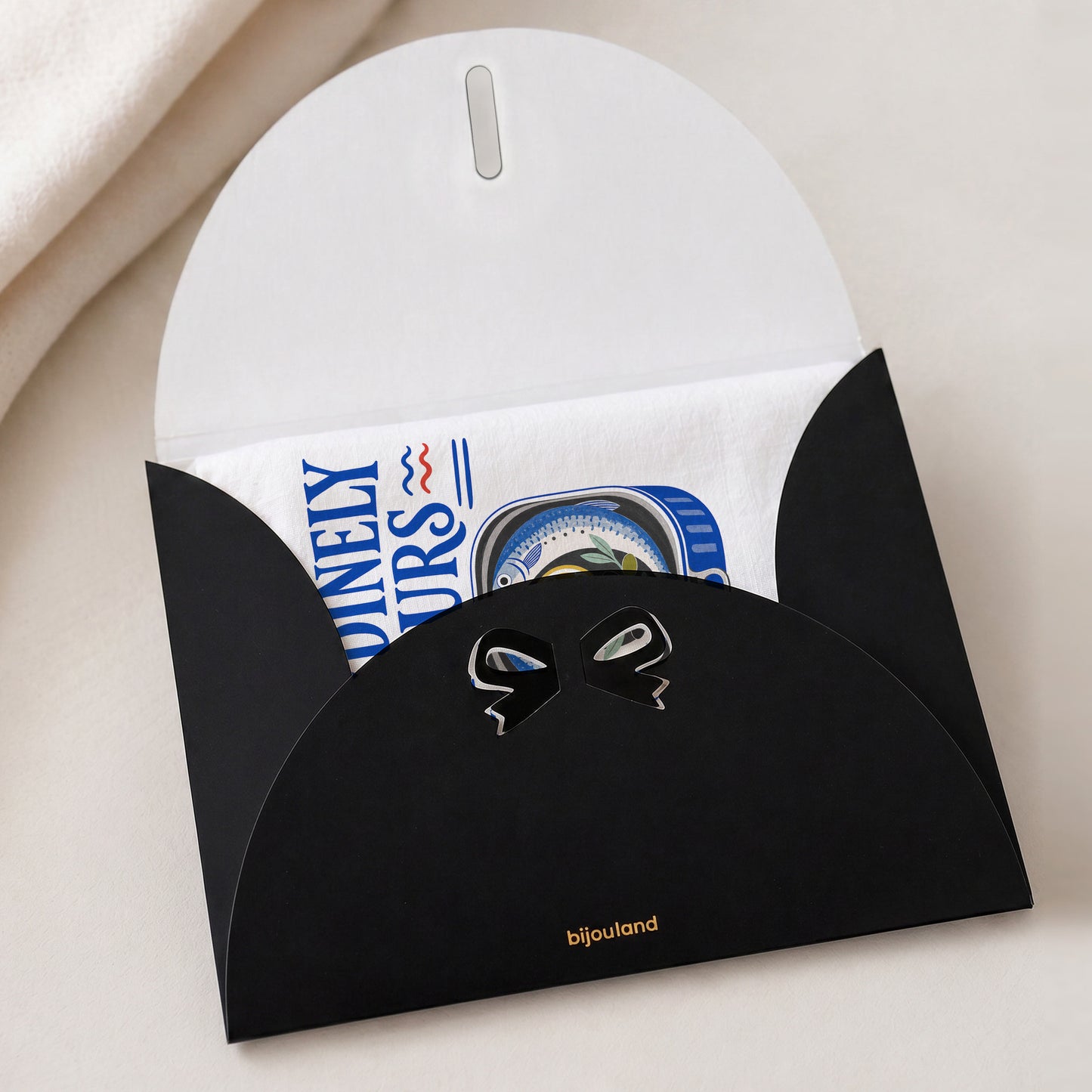 Sardinely Yours tea towel shown with the Bijouland gift-envelope packaging option.