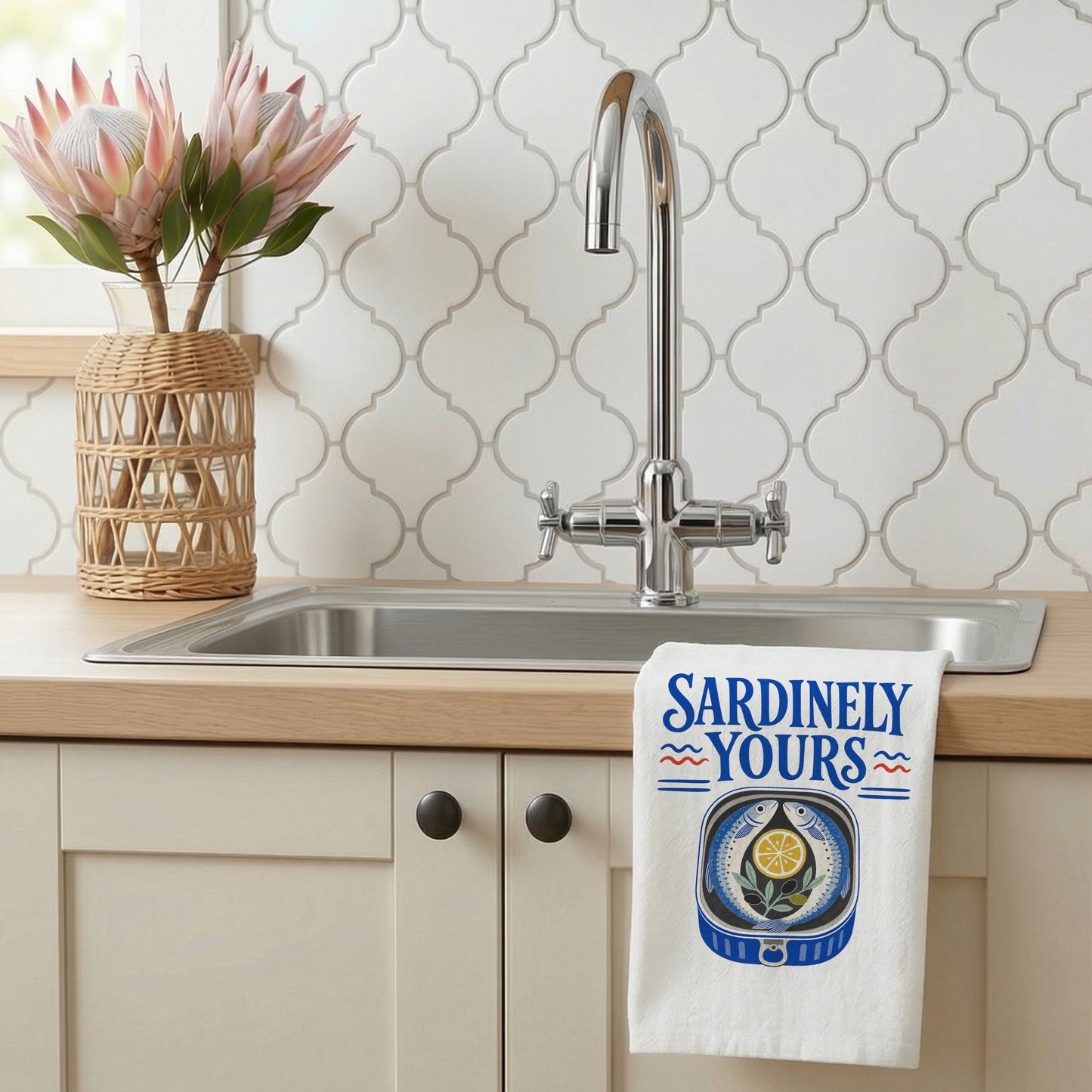 Sardinely Yours tea towel styled beside a kitchen sink with the seafood design visible.