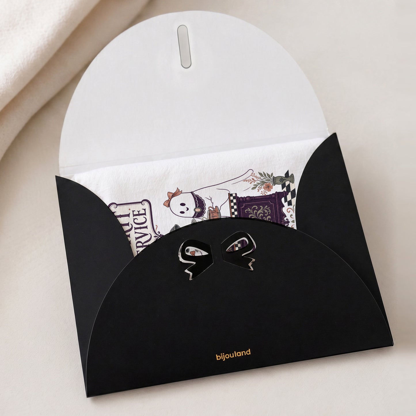 Spirit Service Ghost Halloween Kitchen Towel shown with the black Bijouland gift-envelope packaging option.