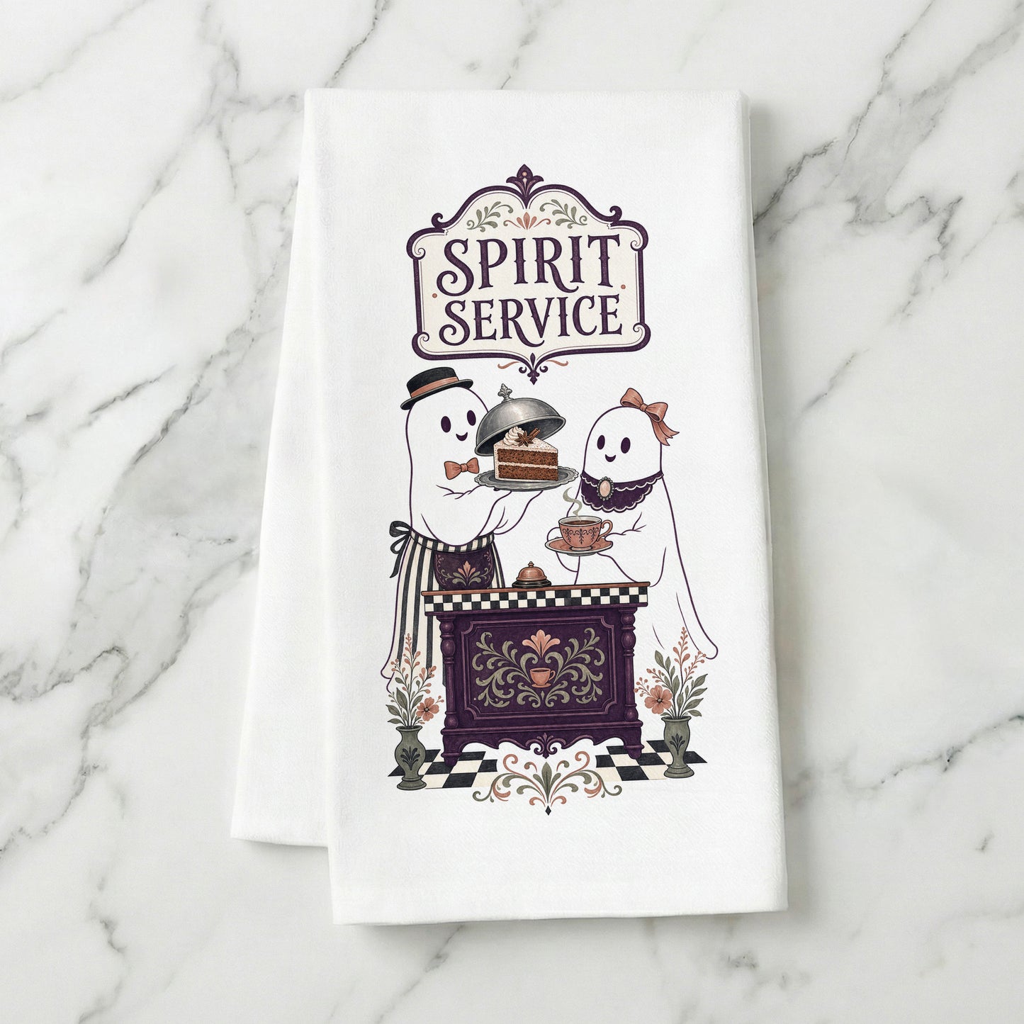 Spirit Service Ghost Halloween Kitchen Towel folded on white marble, with two friendly ghosts serving cake and tea at a vintage cafe counter clearly shown.
