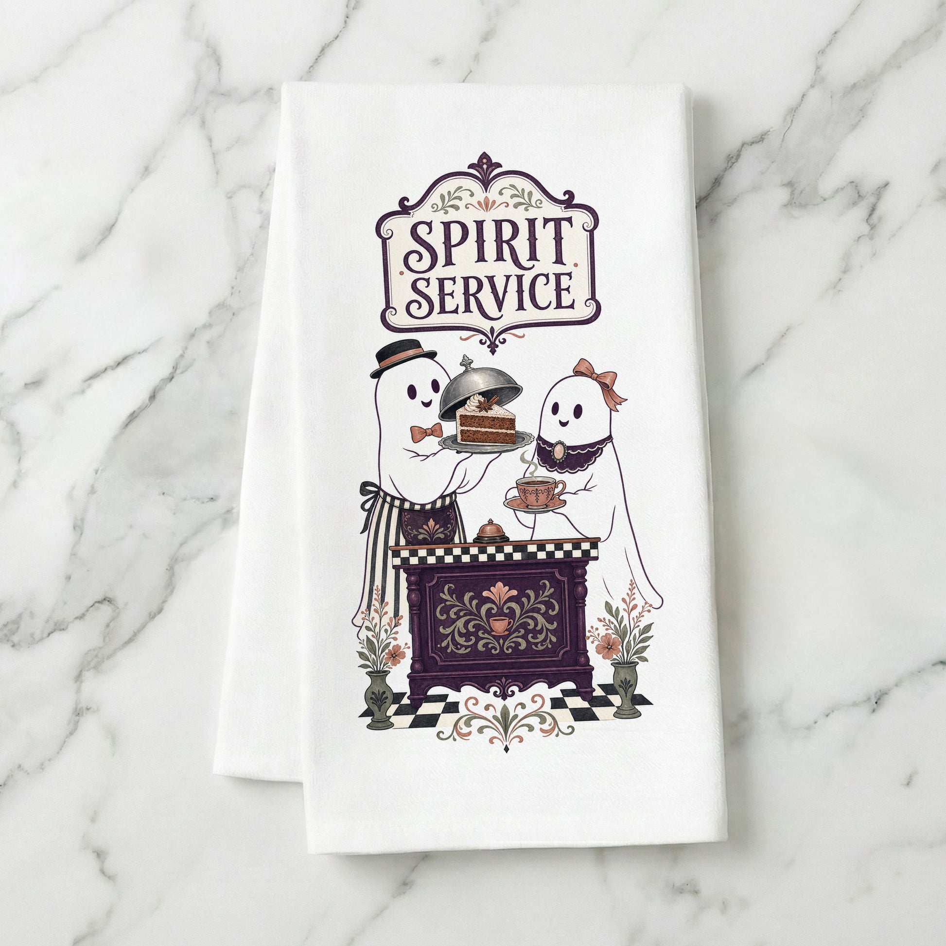 Spirit Service Ghost Halloween Kitchen Towel folded on white marble, with two friendly ghosts serving cake and tea at a vintage cafe counter clearly shown.