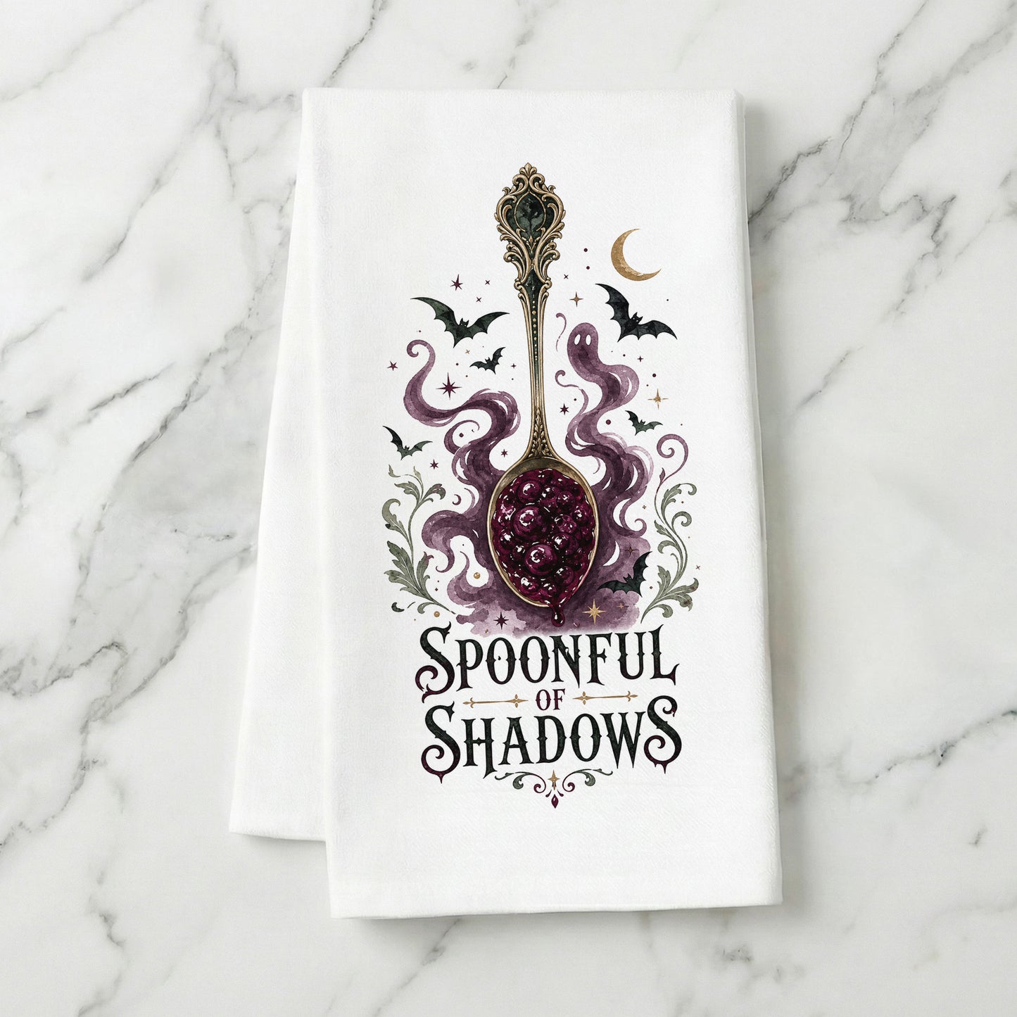 Spoonful of Shadows Gothic Halloween Kitchen Towel folded on white marble, with ornate spoon, berry jam, curling ghost shapes, bats, and crescent moon clearly shown.
