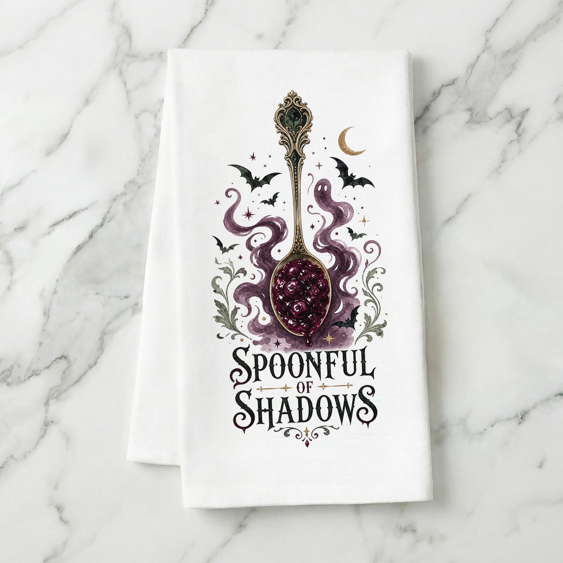 Spoonful of Shadows Gothic Halloween Kitchen Towel folded on white marble, with ornate spoon, berry jam, curling ghost shapes, bats, and crescent moon clearly shown.