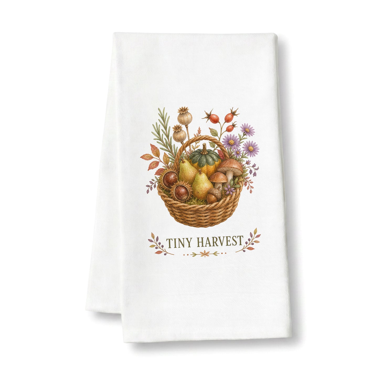Tiny Harvest Autumn Tea Towel folded on a clean white background, showing woven basket filled with pears, squash, mushrooms, chestnuts, herbs, and flowers.