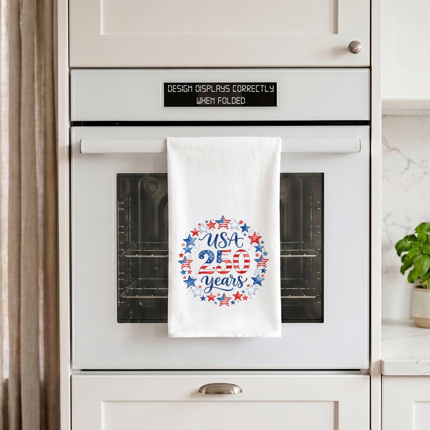 USA 250 Years Stars tea towel hanging on an oven handle