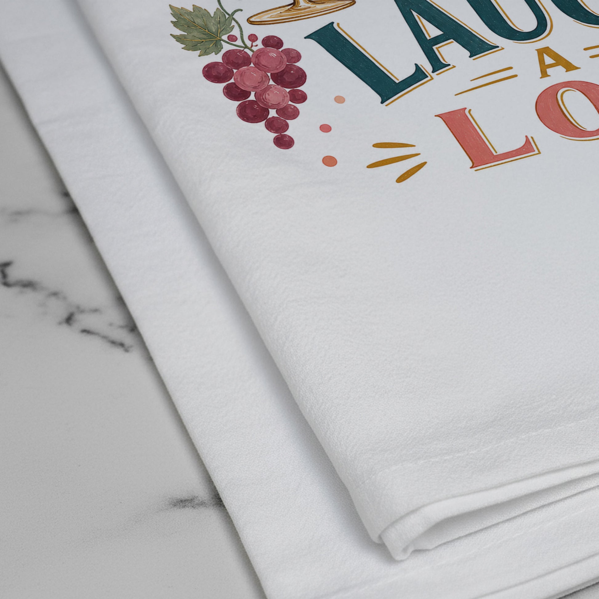 Close-up of the Wine a Little, Laugh a Lot artwork printed on the cotton tea towel.