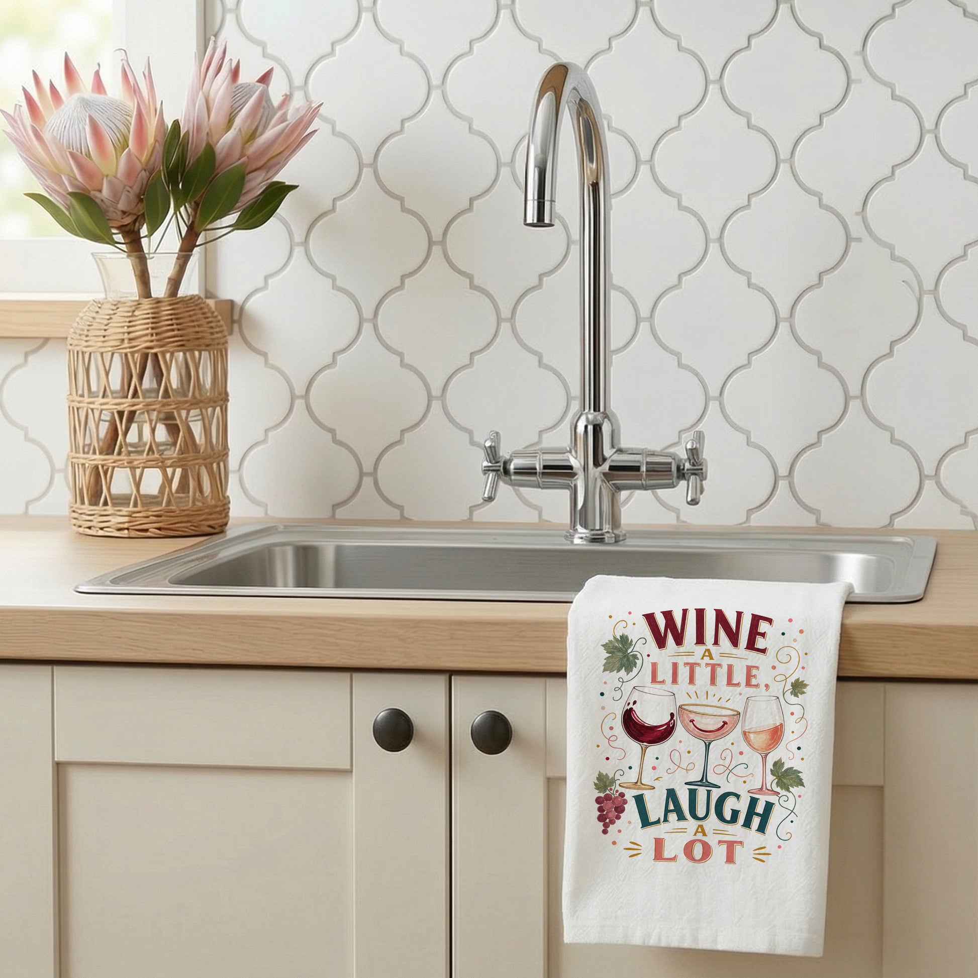 Wine a Little, Laugh a Lot tea towel styled beside a kitchen sink.